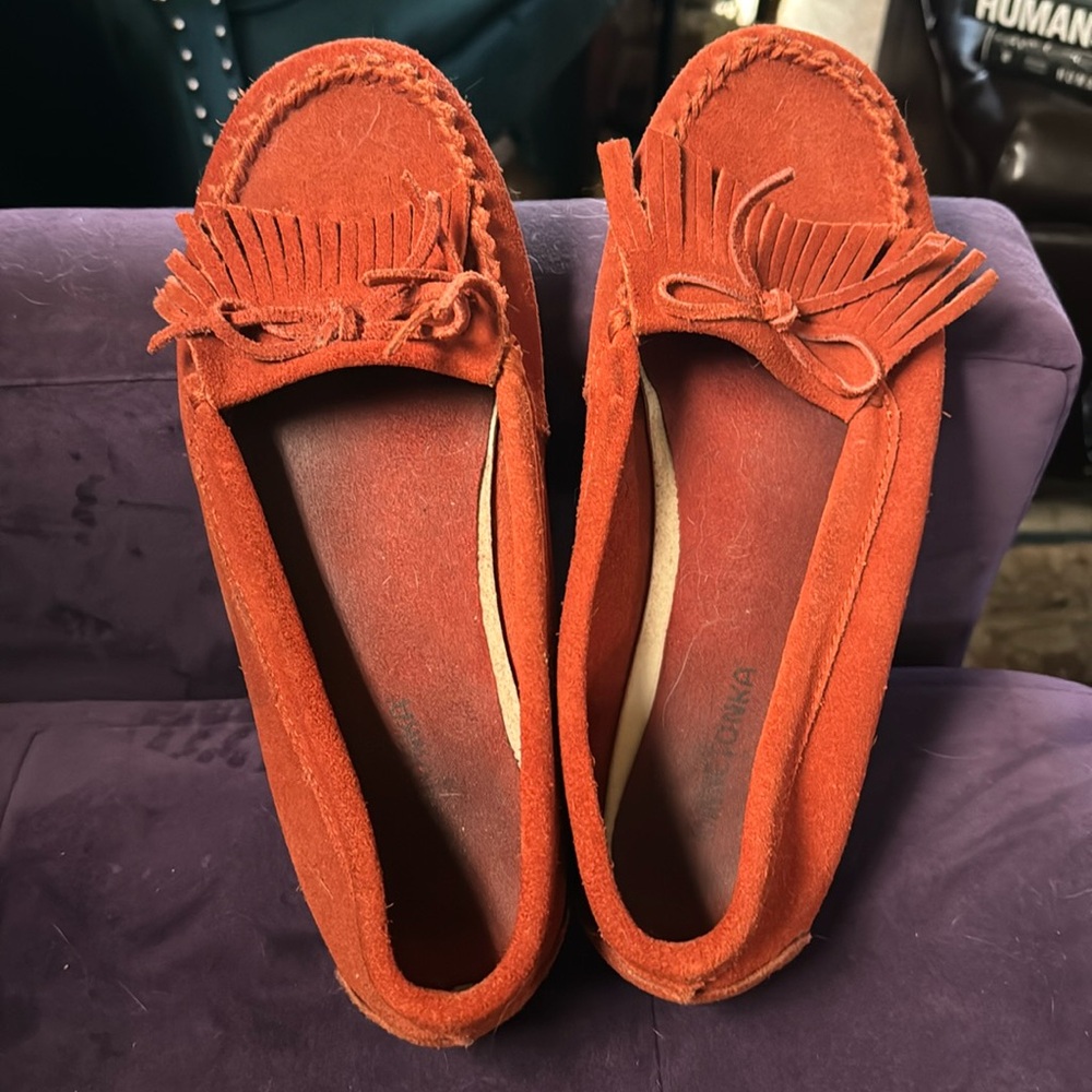 Orange Minnetonka Kilty hardsole moccasins.